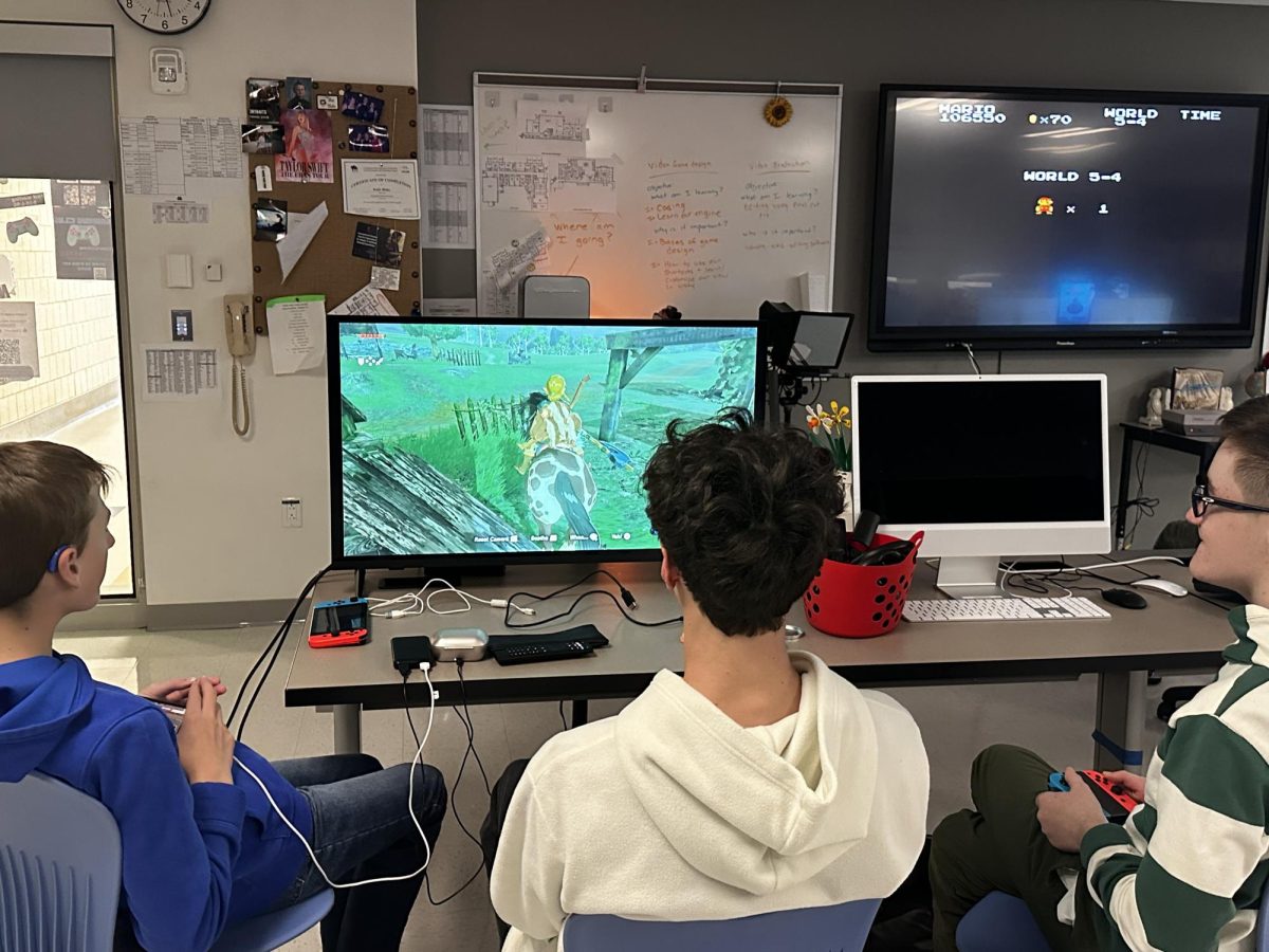 From left, Jack Smith, Domenic DiStefano, and Jack Rinko enjoy playing a game together in Video Game Club, an after-school group where students collaborate using a wide range of technology and modern media tools. (Courtesy of Katie Blake)