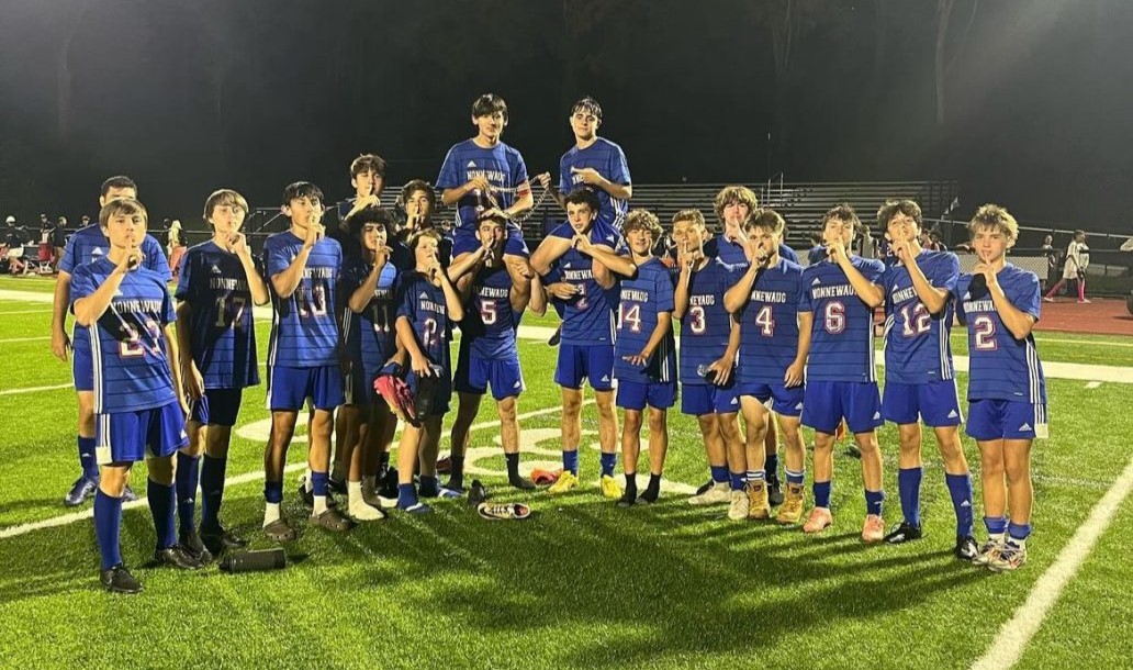 The Nonnewaug boys soccer team celebrates after a win against Lakeview under the lights. (Courtesy of Nonnewaug Boys Soccer/Instagram)