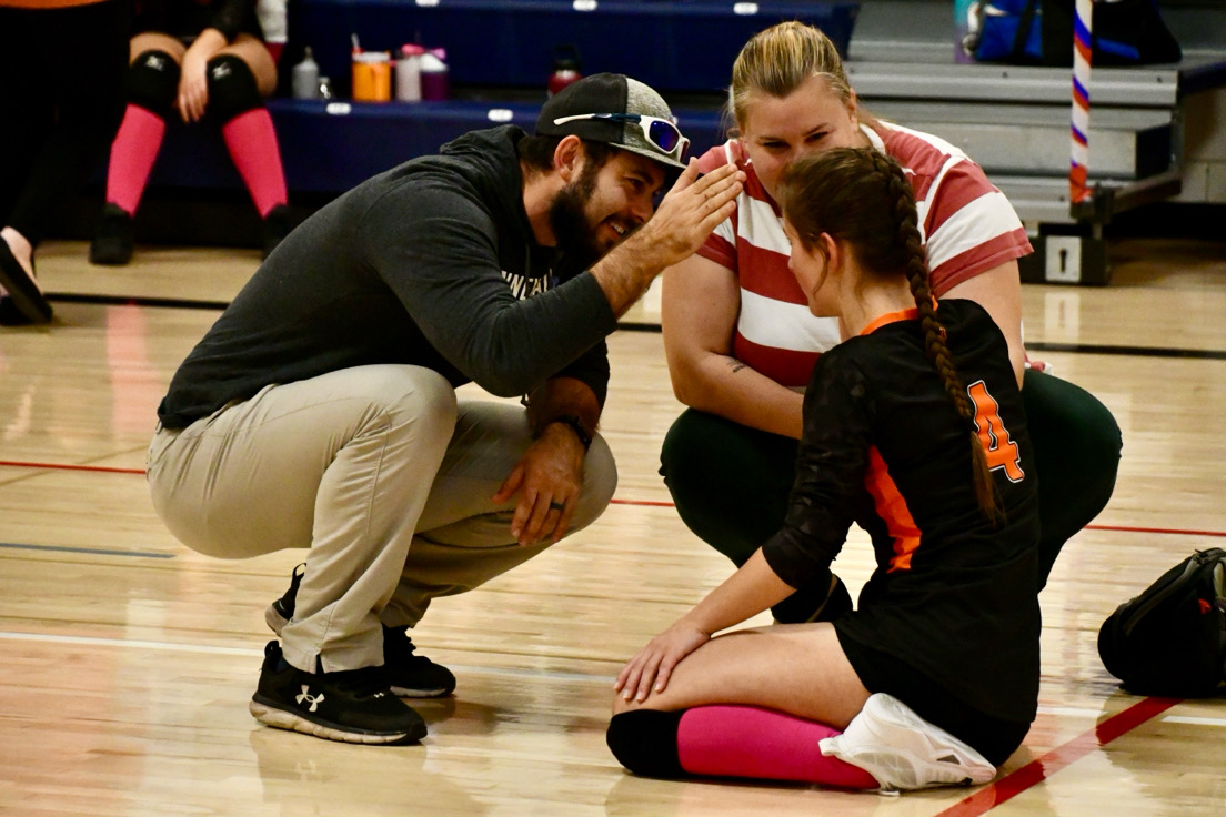 Nonnewaug athletic trainer Sean McGee tends to an injured Terryville player during an Oct. 16 volleyball match.