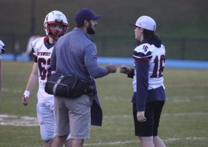 Nonnewaug athletic trainer Sean McGee fist pumps a player at a Northwest United football game last season. (Courtesy of Noreen Chung)