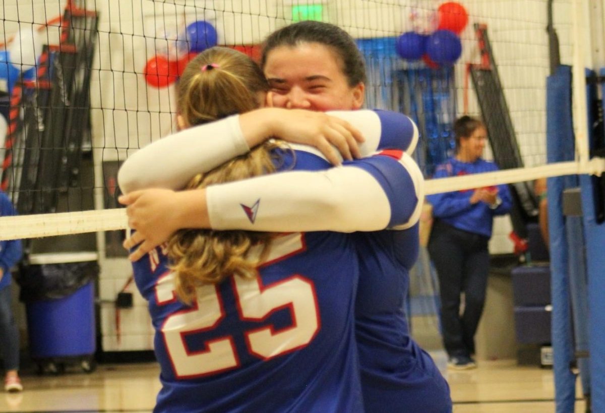 Sophomore Ava Rickenbach (25) hugs senior Emma Jackson after reading her senior speech during Nonnewaug’s volleyball senior ceremony on Oct. 16. They have been best friends since last year, and with volleyball season ending in a couple of weeks, emotions were high at this game. 