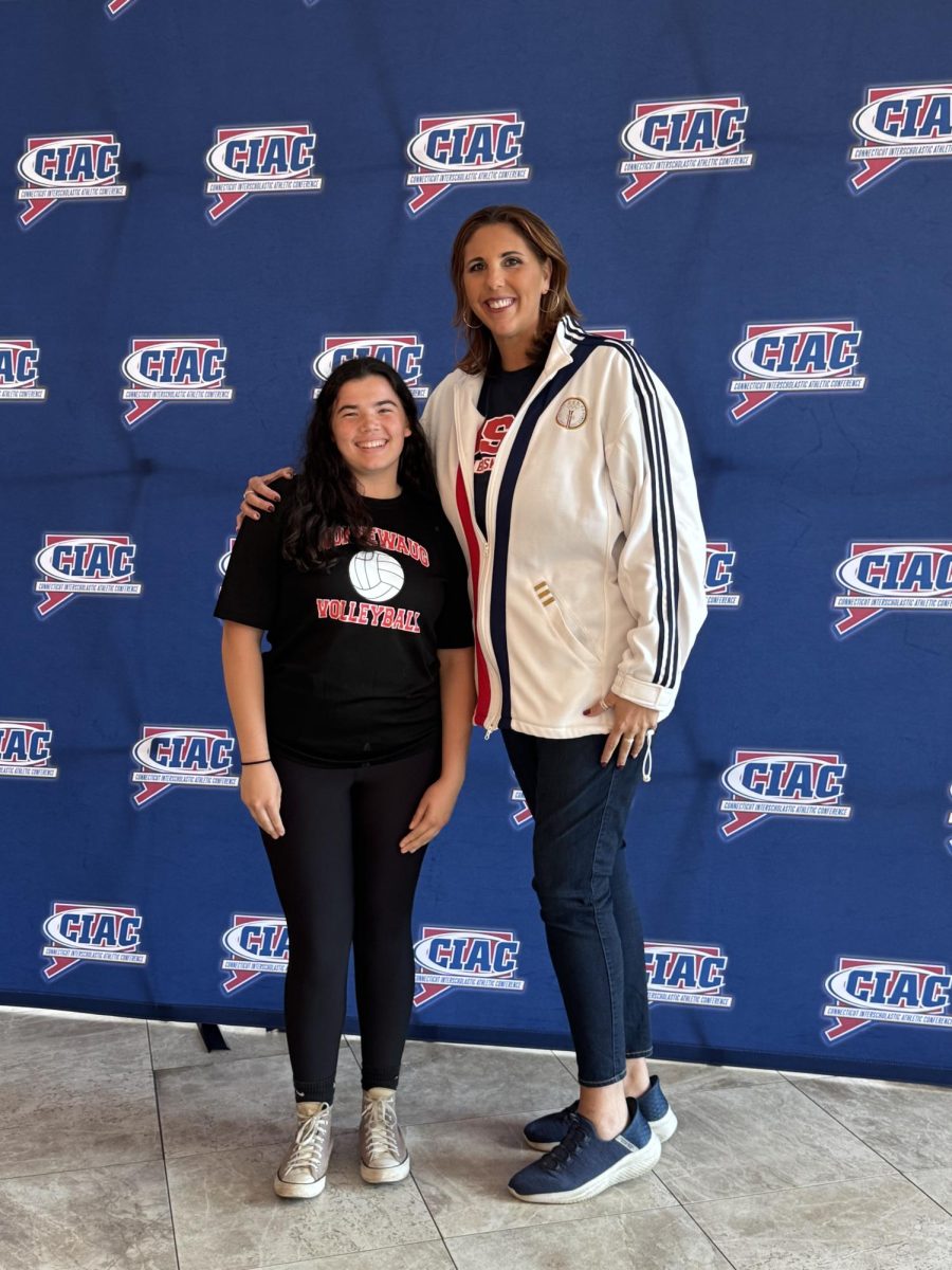 Senior Emma Jackson stands with basketball Olympic gold medalist Kara Wolters at this year's CIAC Sportsmanship conference.
