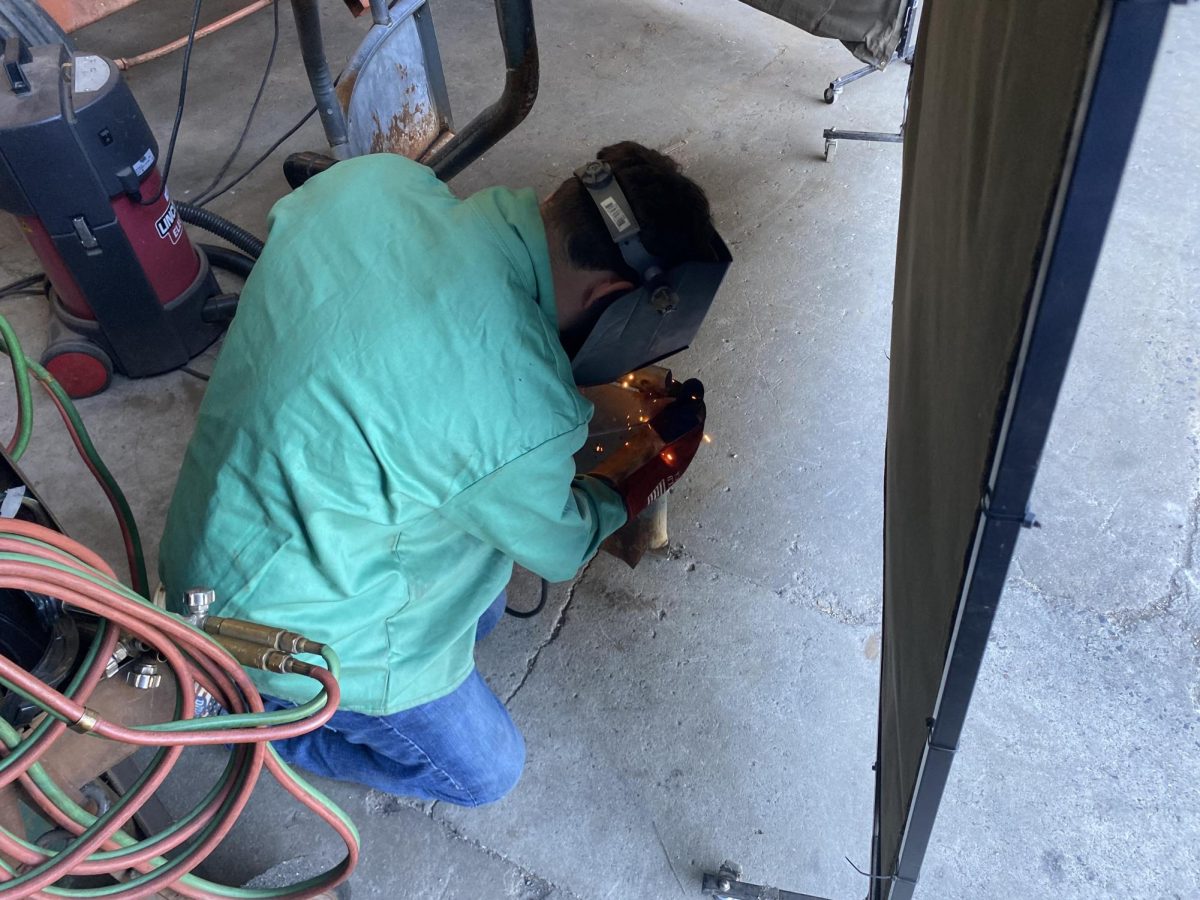 NHS junior Nicolas Sniffin welds the hay feeder together that the agriculture mechanics is building. It's common for Sniffin and his classmates to work alongside classmates to complete class projects. 