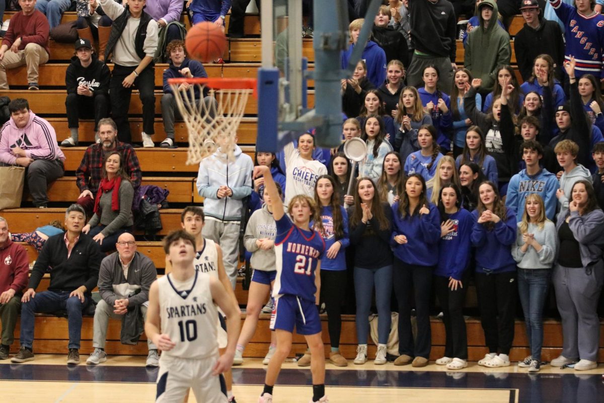 Robert Metcalfe makes a 3-point shot at the Nonnewaug rivalry game against Shepaug on Jan. 2. (Courtesy of Noreen Chung) 
