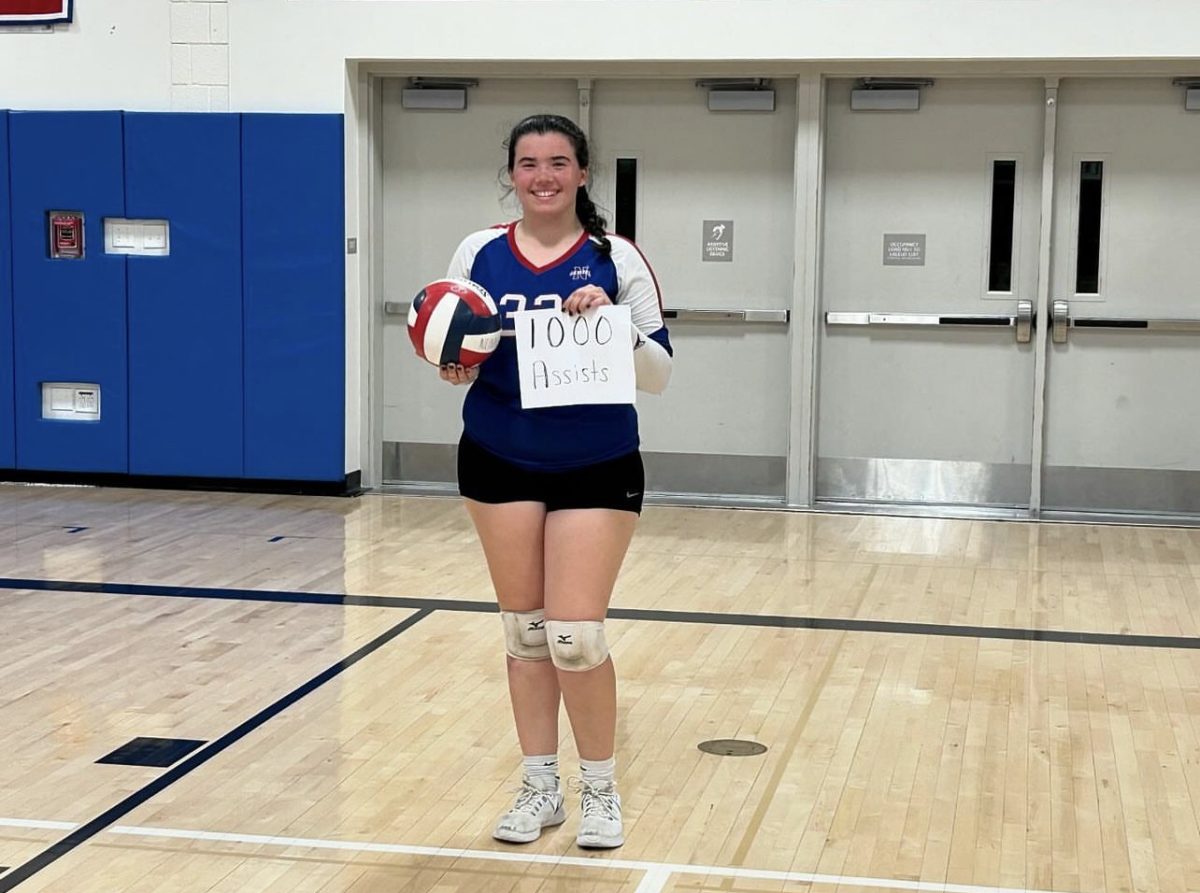 Senior Emma Jackson poses after her state volleyball game on Nov. 6, when she reached 1,000 assists for her career. (Courtesy of Kyle Brennan)