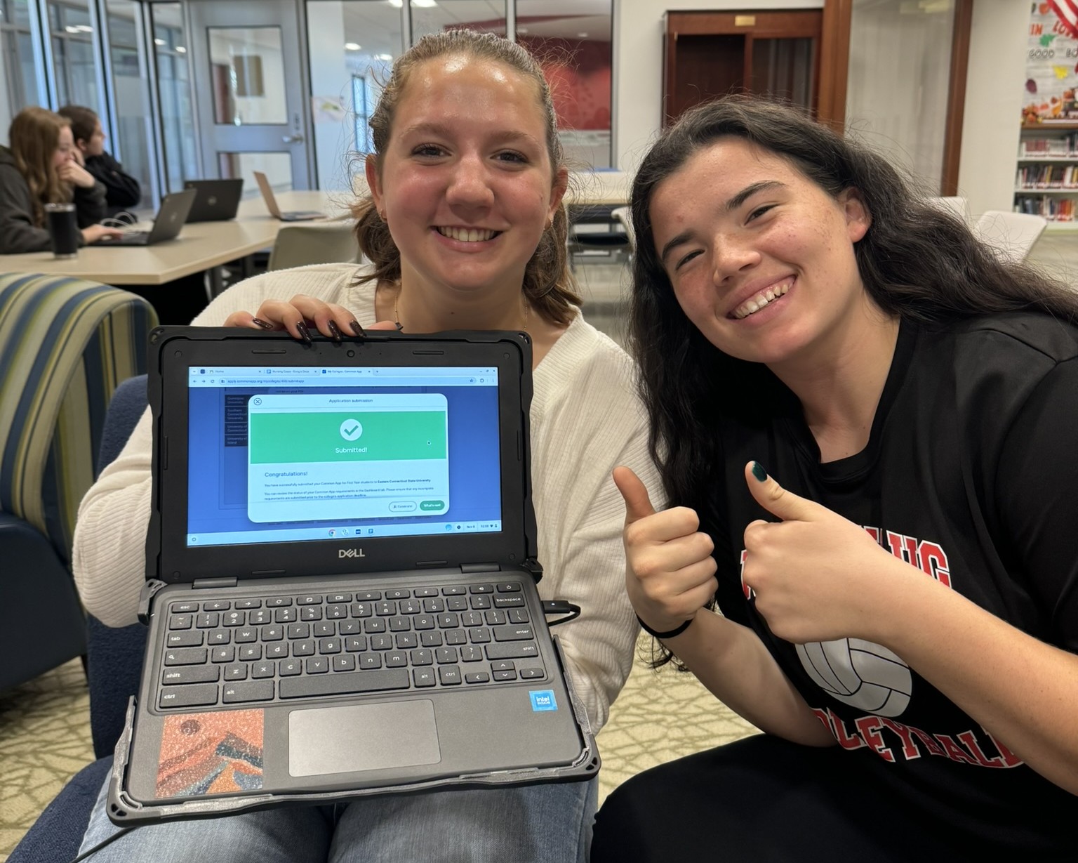 Seniors Lexi Sweeney, left, and Emma Jackson pose after Sweeney completed a college application. (Courtesy of Kathy Green)