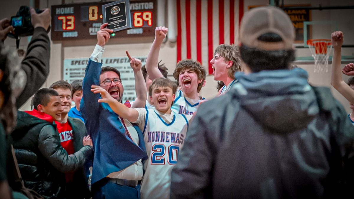 The Nonnewaug boys basketball team celebrates after winning the Berkshire League championship game on March first.
