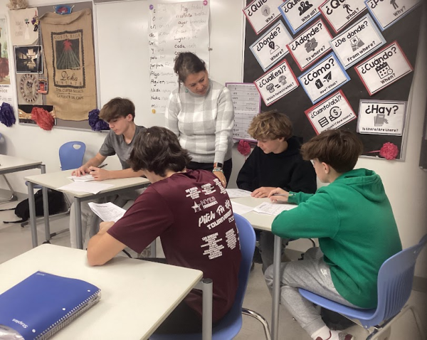 Karen Sandor, a Spanish teacher at Nonnewaug High School, instructs freshmen, from left, Zachary Santopietro, Owen Hustek, Michael Platt, and Darren Sullivan on their coursework.