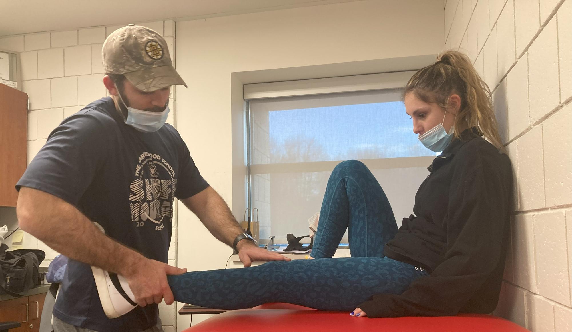 Nonnewaug athletic trainer Sean McGee, left, works with Samantha Conti during pre-habilitation workouts following her ACL tear in December 2021. (Courtesy of Kyle Brennan)