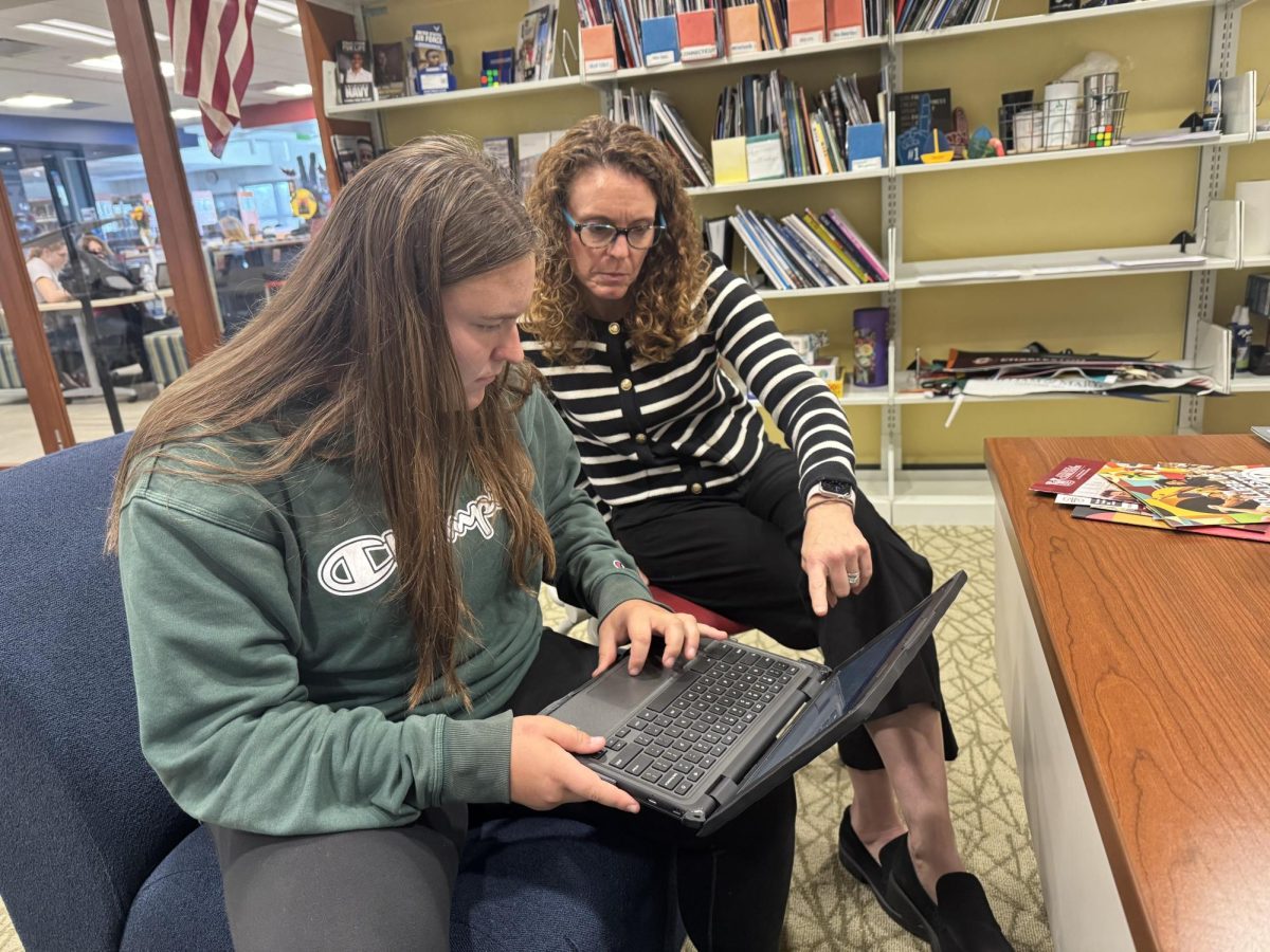 Nonnewaug College and Career Resource Center counselor Kathy Green, right, works with senior Grace Schmidheini on her college applications. Nonnewaug seniors have three different deadlines for their college applications. 