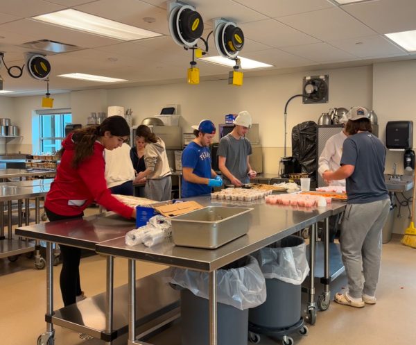 John Dominello's Advanced Culinary class prepares the individual cups that will be added to each box. These meals will be handed out on Dec. 5.