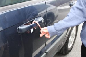 President of Student Council Ada Gorka places a candy cane onto a car door handle at Nonnewaug High School on Dec. 20.