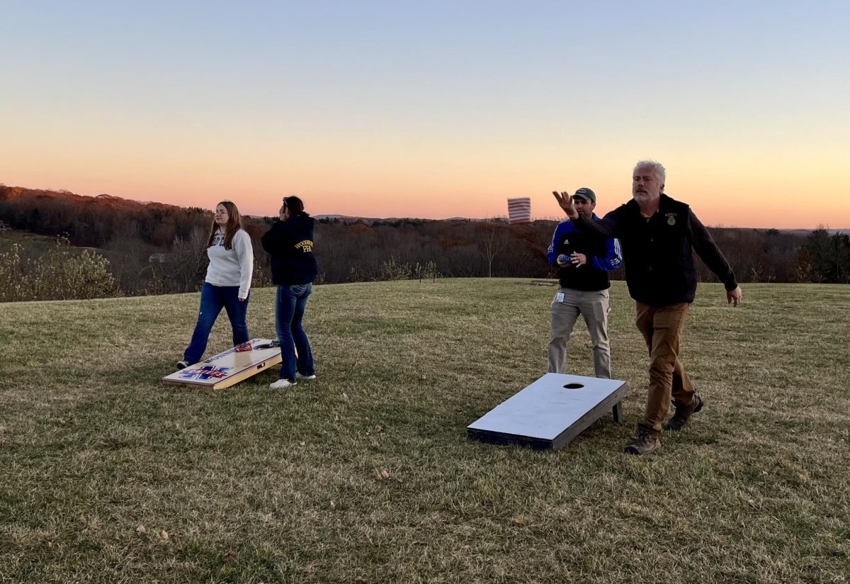 Students and teachers from Nonnewaug and Wamogo compete in corn hole during the District 1 social.