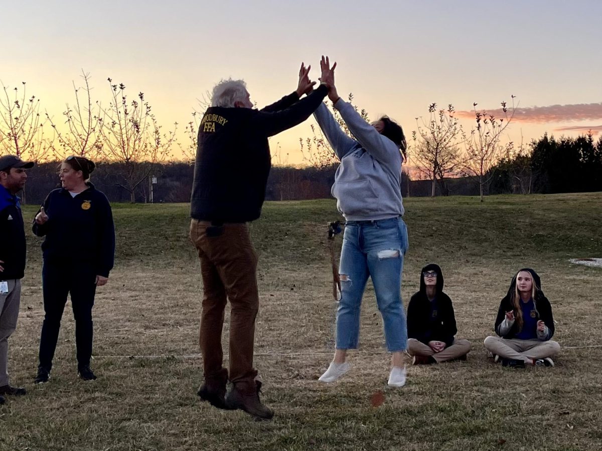 Nonnewaug teachers Eric Birkenberger and Leanne Foster embrace in a celebratory high-five during the District 1 social.