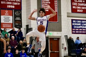 Brady Herman (5) attempts to save the ball but lets it out of bounce on Jan. 27 during the NHS vs. Waterbury Career Academy game. 