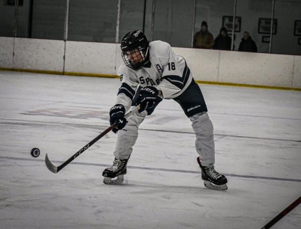 Peyton Thomas (18) attempts to catch the puck on Jan. 15 during the Shepaug Spartans hockey game against Housatonic. 