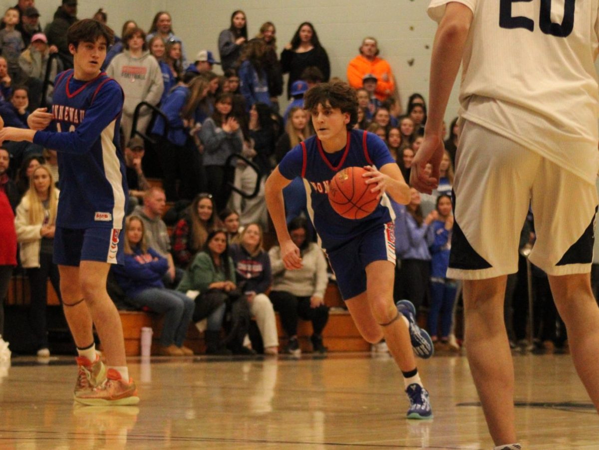 Junior Brady Herman dribbles down the court during Nonnewaug boys basketball game against Shepaug on Jan 3.  