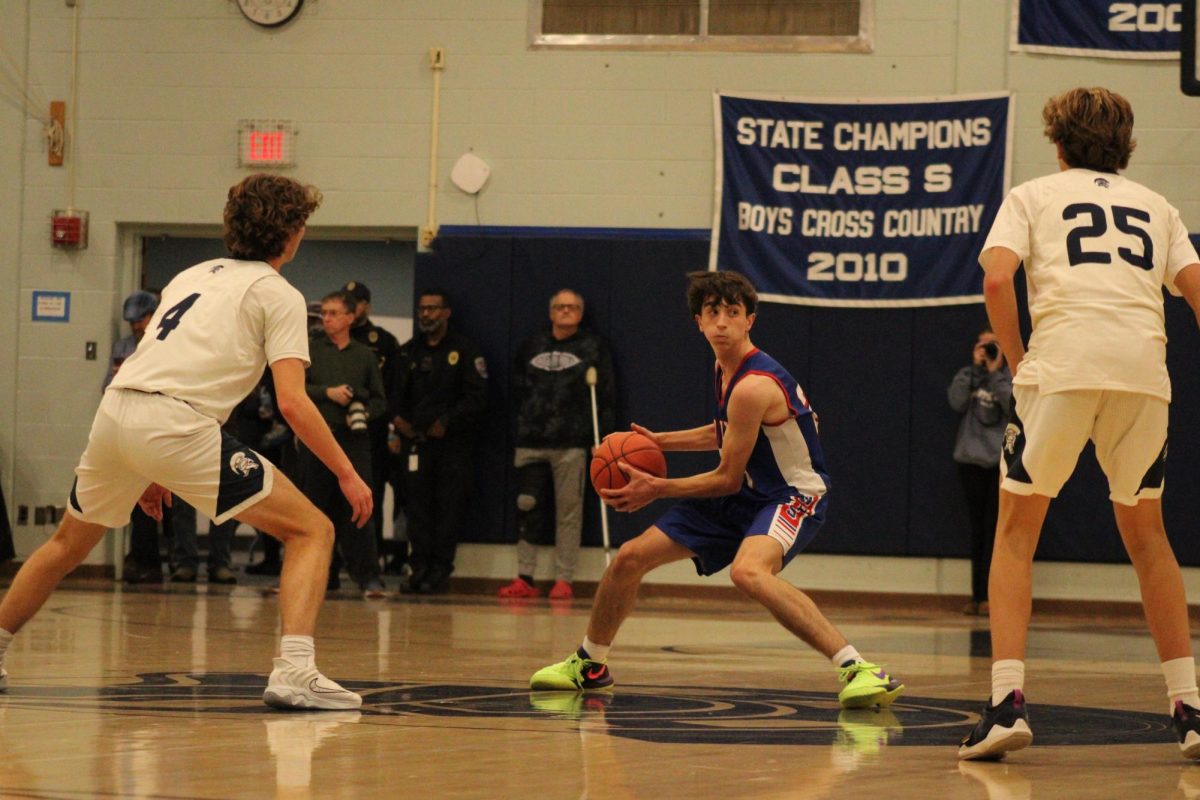 Sophomore Max Nichols looks to pass the ball during Nonnewaug Boys basketball game against Shepaug on Jan 3.  