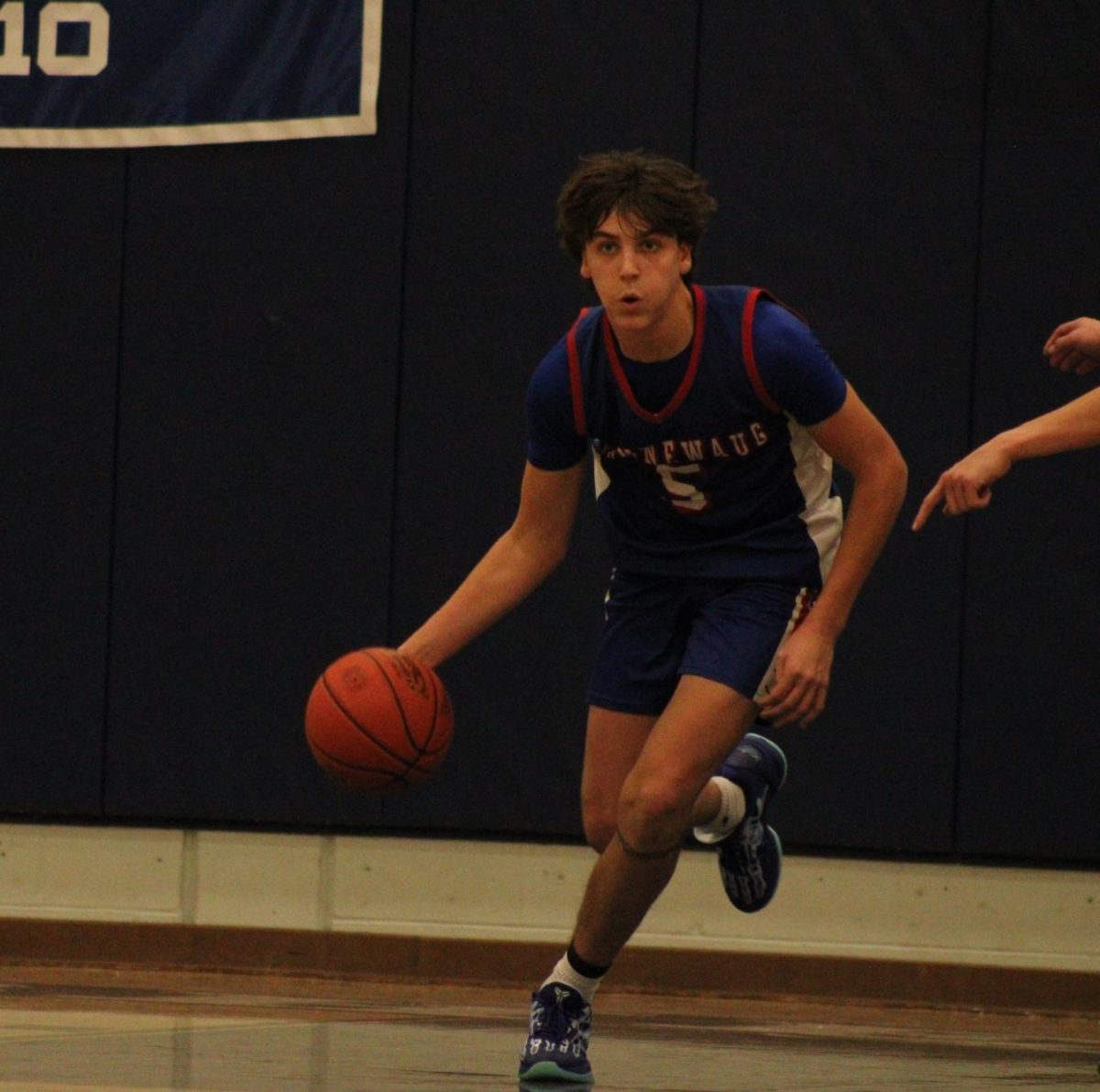 Junior Brady Herman dribbles the ball during Nonnewaug boys basketball game against Shepaug on Jan 3.  