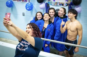 Nonnewaug swim coach Abby Walsh, front left, takes a selfie with swimmers, from left, Maddie Strubbe, Julia Longoria, Bianca Gracia, Olivia Bernardi, and Scott Viveros during the team's senior night in 2023. (Courtesy of Derek Ward)