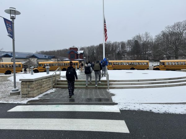 Students leaving a long school day after a light snow came down throughout the day. Cold temperatures bring a quiet numbness to the tiring day that marked the beginning of the week in the doldrums of winter. 