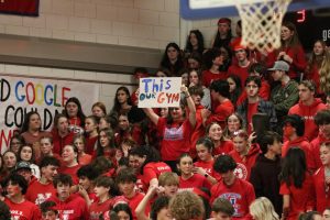 Campbell Bologna, a 2024 Nonnewaug graduate, holds a sign at last year’s home red-out game against rival Shepaug. Most of the school was in attendance for both home and away games. (Courtesy of Noreen Chung)

