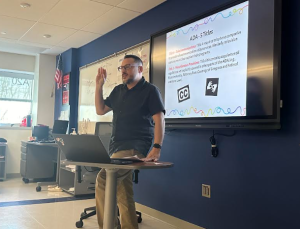 Chad Williams, the Nonnewaug ASL teacher, signs to his students during class.