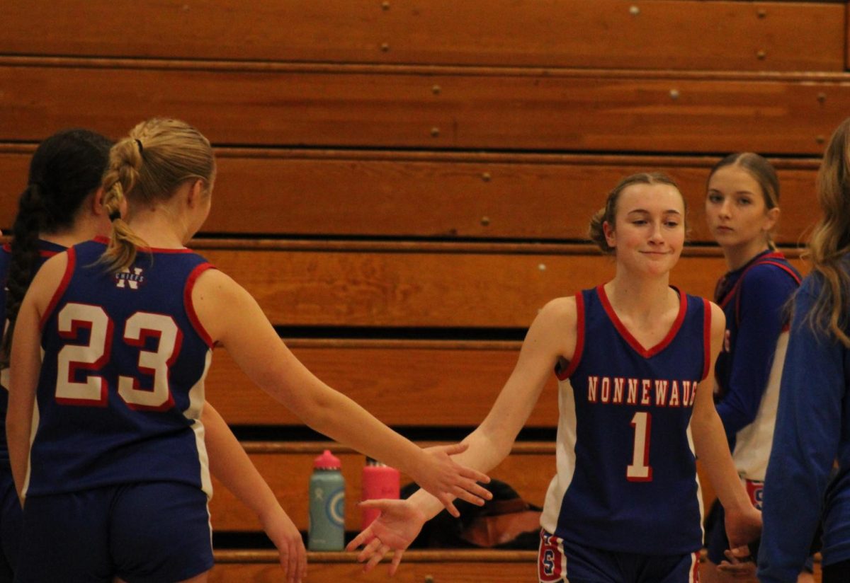 Freshman Gemma Hedrei goes through the handshake line during Nonnewaug girls basketball game against Shepaug on Jan. 3. 