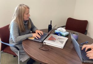 Suzi Greene works during a meeting at Nonnewaug High School. She is the school's interim assistant principal.