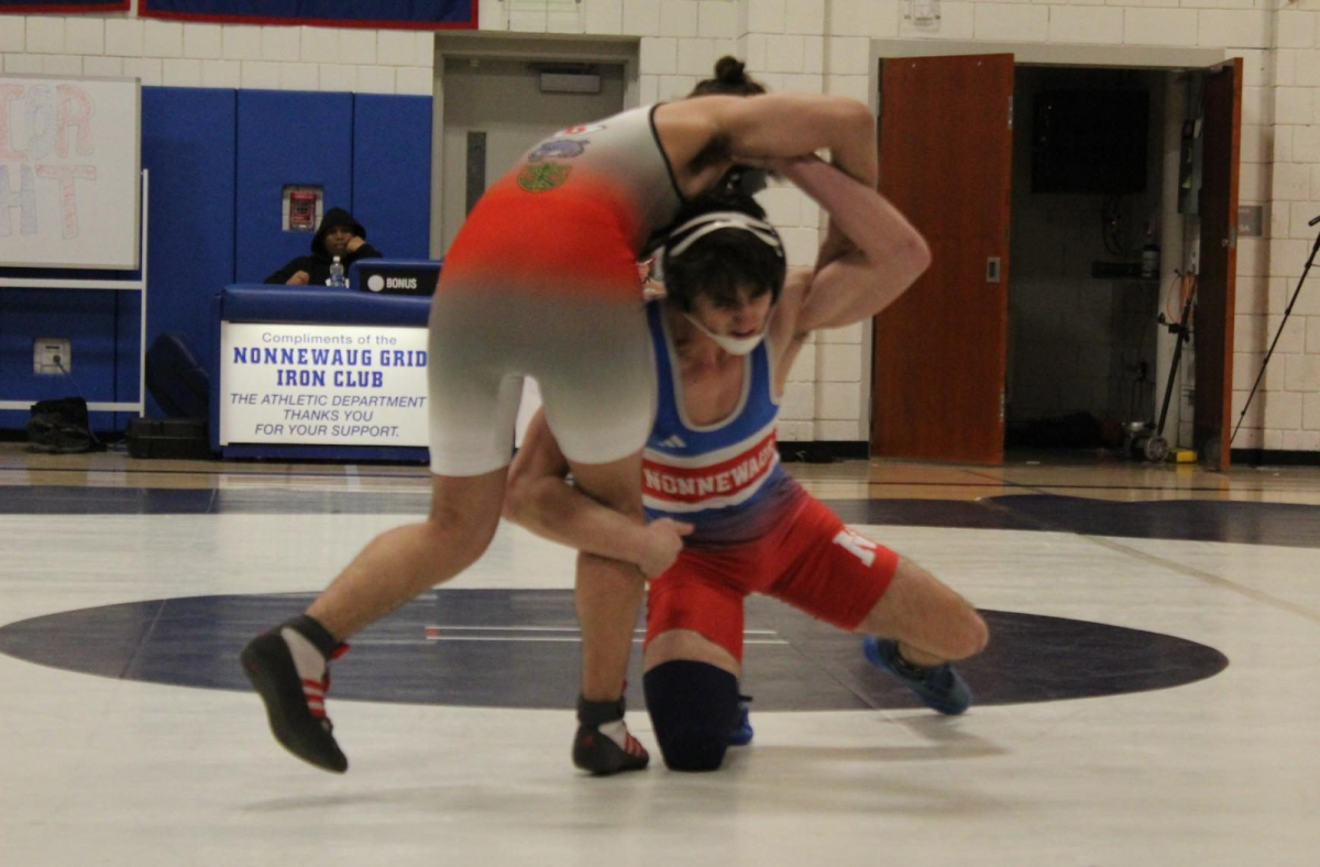 Nonnewaug’s Jeff Bernardi starts to flip his opponent onto the mat, gearing up for another pinfall Feb. 7, 2024 against Derby/Oxford/Holy Cross. (Courtesy of Jules Bellagamba)