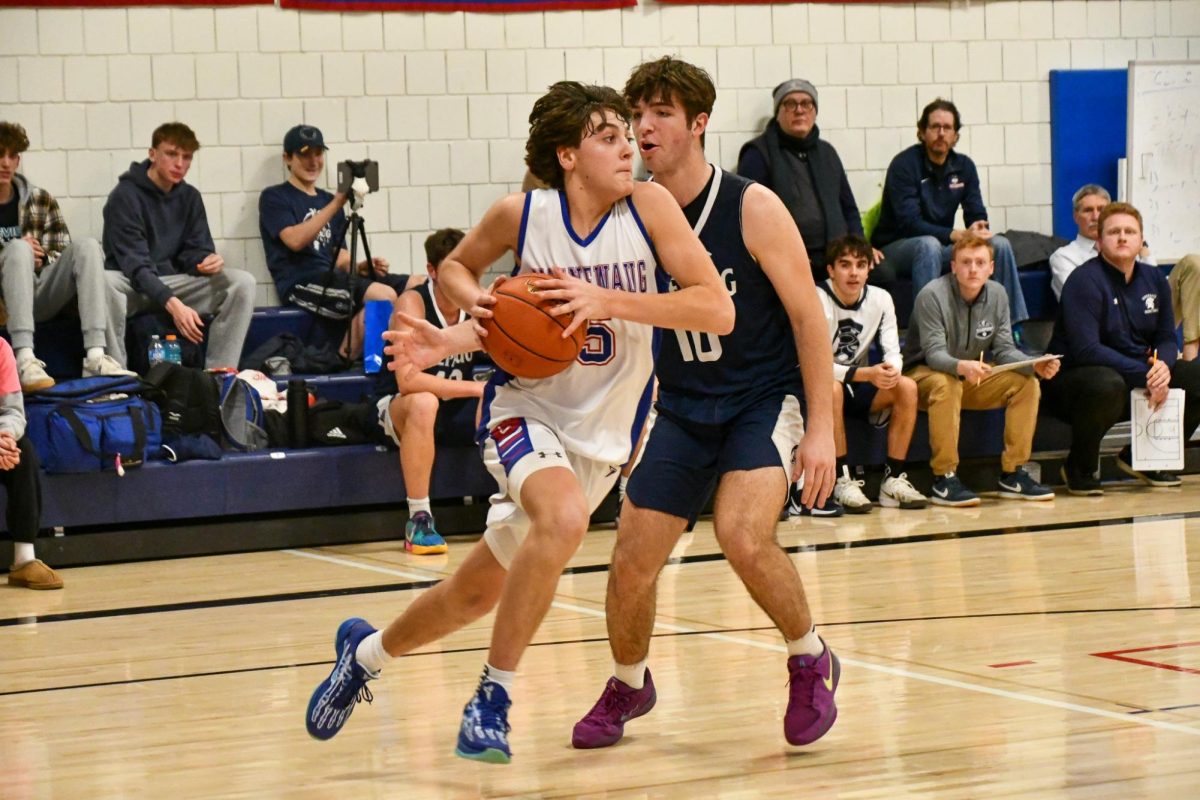 Brady Herman (5) carries the ball as he runs up to the hoop to make a shot on Feb. 7  during one of the annual rivals Red out Nonnewaug vs. Shepaug home game in support of LLS. 