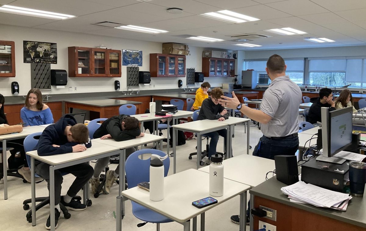 Nonnewaug science teacher Joshua Kornblut engages with his class, despite a lack of attention from students.