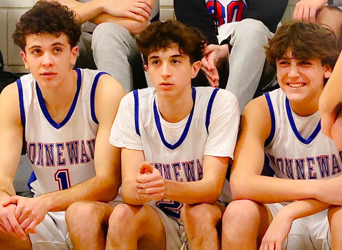 Nonnewaug sophomore Max Nichols, center, prepare to get called for starting lineups before the boys basketball game against Gilbert on Jan. 11. Nichols admits that staying positive is a challenging part of sports. (Courtesy of Noreen Chung)