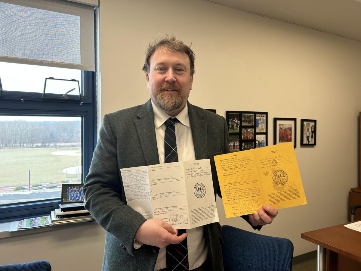 Assistant principal Declan Curtin displays his report cards from first and second grade. Both years he acquired perfect attendance, showing how being an active learner has always been one of his top priorities.