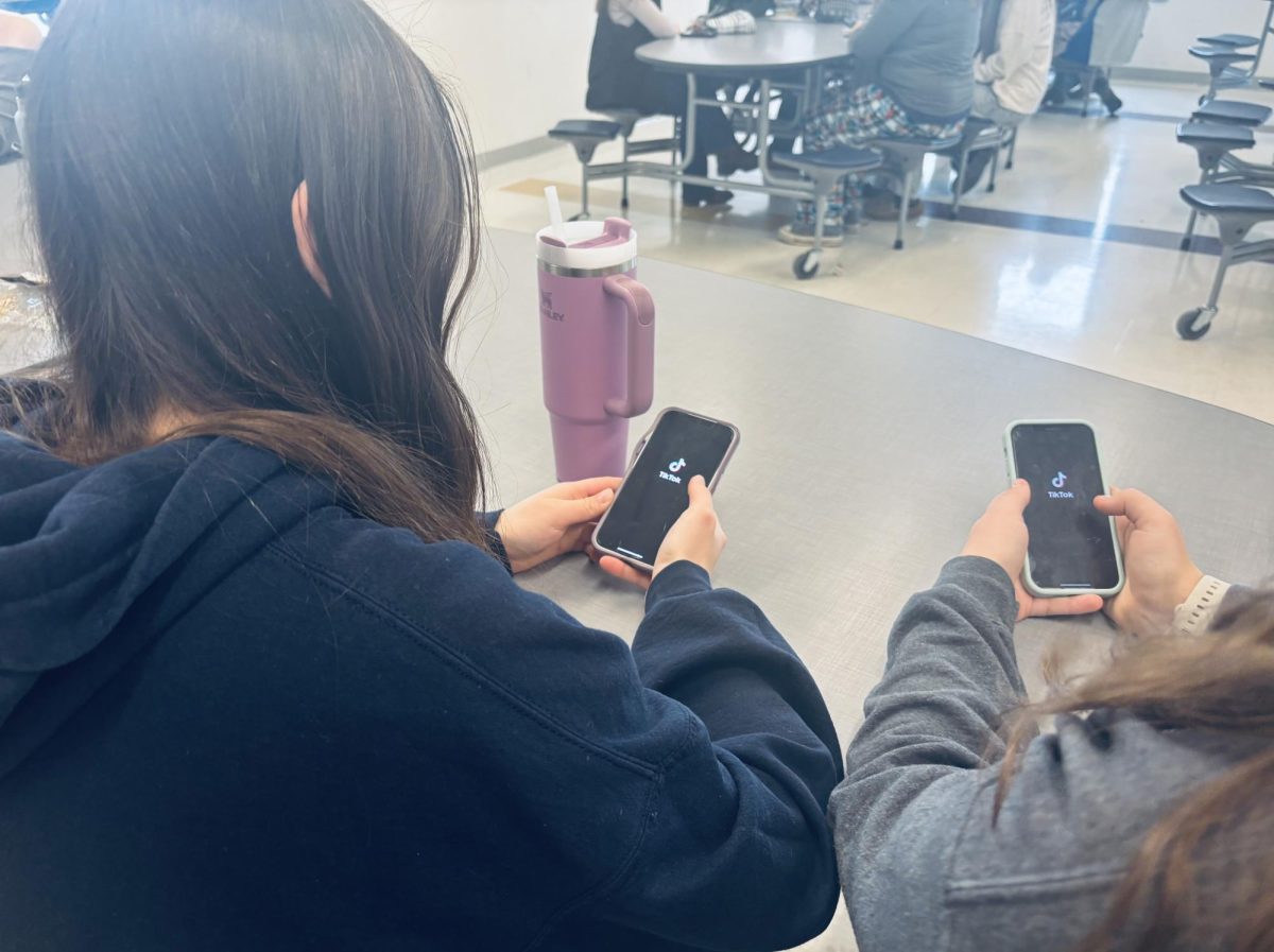 Freshmen Molly Daines and Stephine Crlscuolo scrolling through the tik tok during their free lunch period for entertainment purposes. Both 9th grade students have ambivalent feelings toward the app and its addictive qualities. 