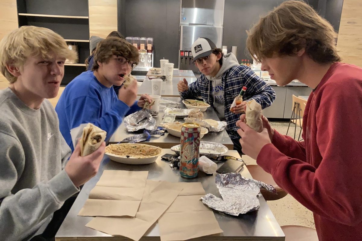 Members of the Nonnewaug Class of 2023, from left, Andrew Greene, Zach Hellwinkle, Diego Razo, and Christian Swanson eat Chipotle during a class fundraiser in Southbury. Many class councils use Chipotle fundraisers to benefit class events like prom. (Courtesy of Kyle Brennan)