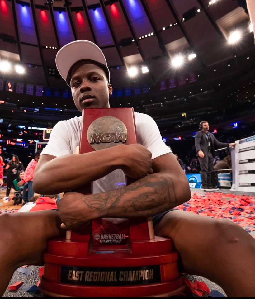 Florida Atlantic star point guard Johnell Davis clutches the trophy after winning the East Regional championship over No. 3 Kansas State in the 2023 Elite Eight. (Courtesy of Florida Atlantic men's basketball/Instagram)