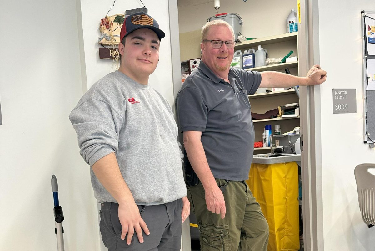 Junior James Gwiazdoski, left, and custodian Clayton Hilpertshauser stand in the cafeteria.