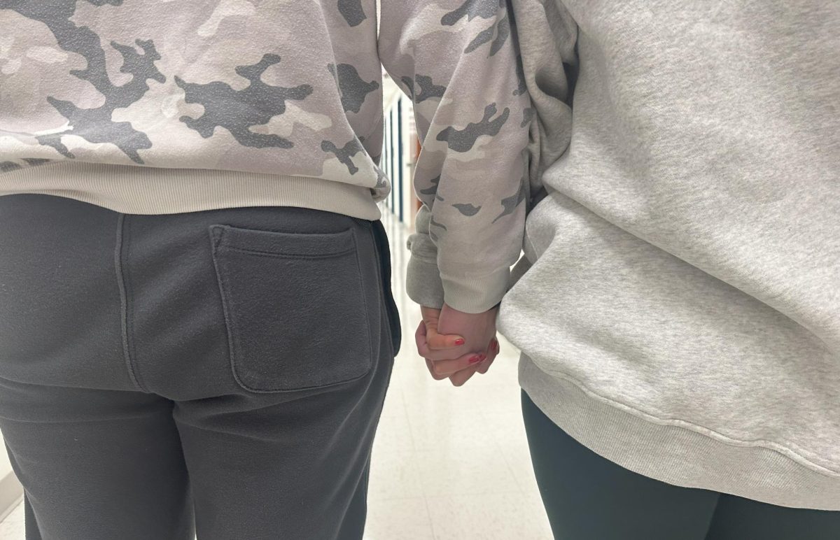 Nonnewaug students hold hands in the hallway during passing time. What's the line where public displays of affection become too much in school?