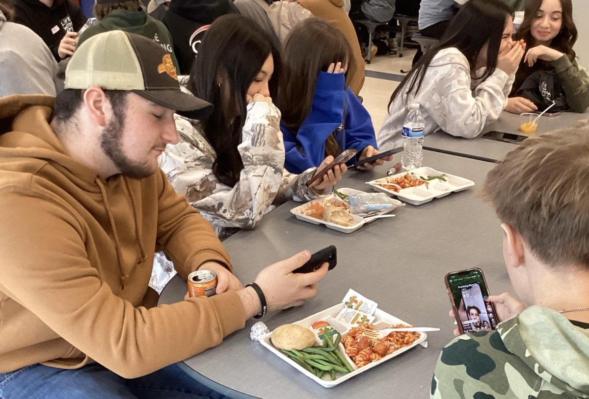 Nonnewaug students scroll through TikTok during lunch. For those who didn't delete the app, TikTok is still available -- for now.