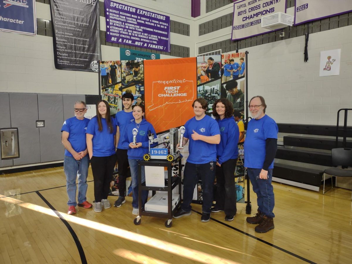 Nonnewaug Robotics Team members stand with a trophy in front of their award winning robot at the State Championship. Despite having few members, this team is accomplished in what they do. (Courtesy of Team Beta)