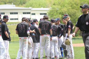 Nonnewaug baseball players group up as they converse during a 2024 game against Northwestern. (Courtesy of Noreen Chung)  
