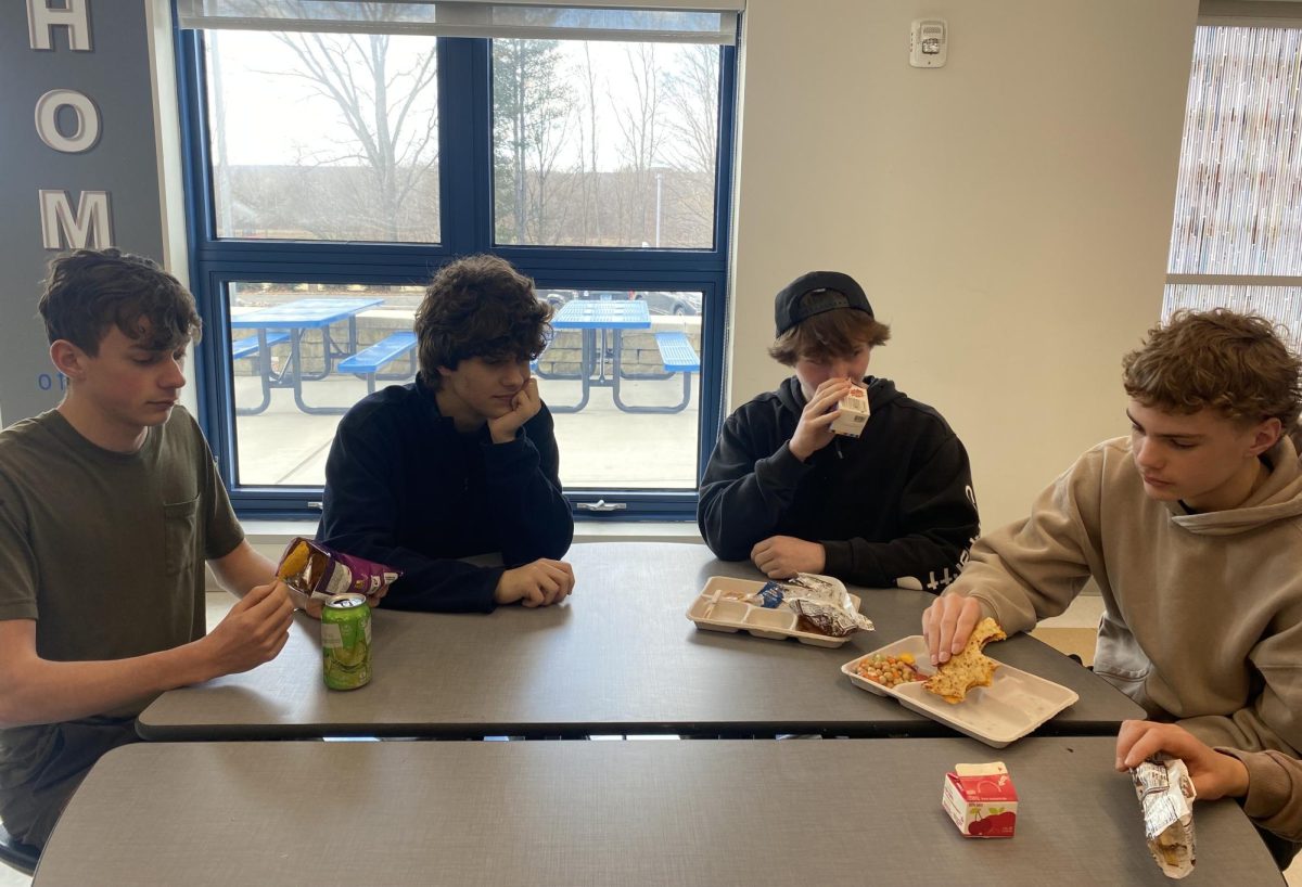 Nesim Iljazi, second from left, sits at lunch with Joseph Abaire, Dylan Loring, and Henry Keil. He is the only one not eating, as it is Ramadan and he is fasting.