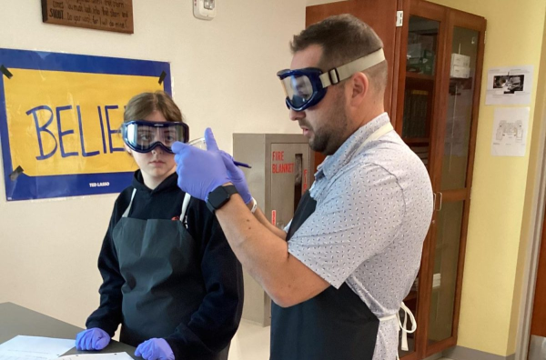 Science teacher Joshua Kornblut demonstrates a lab. He makes sure that all of his students have hands-on learning opportunities. (Chief Advocate archives)