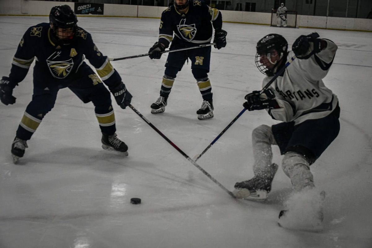 Shepaug hockey player Matt Molleur, right, battles for the puck in a regular-season game. A dangerous hockey play in same position was when Molleur got one of his concussions. (Courtesy of Matt Molleur)