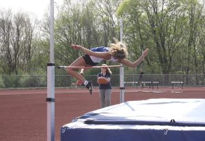Junior Veronika Nicholas, jumps over the bar during the high jump event at the dual meet on April 29th. The girls team beat Shepaug 119-30. 
