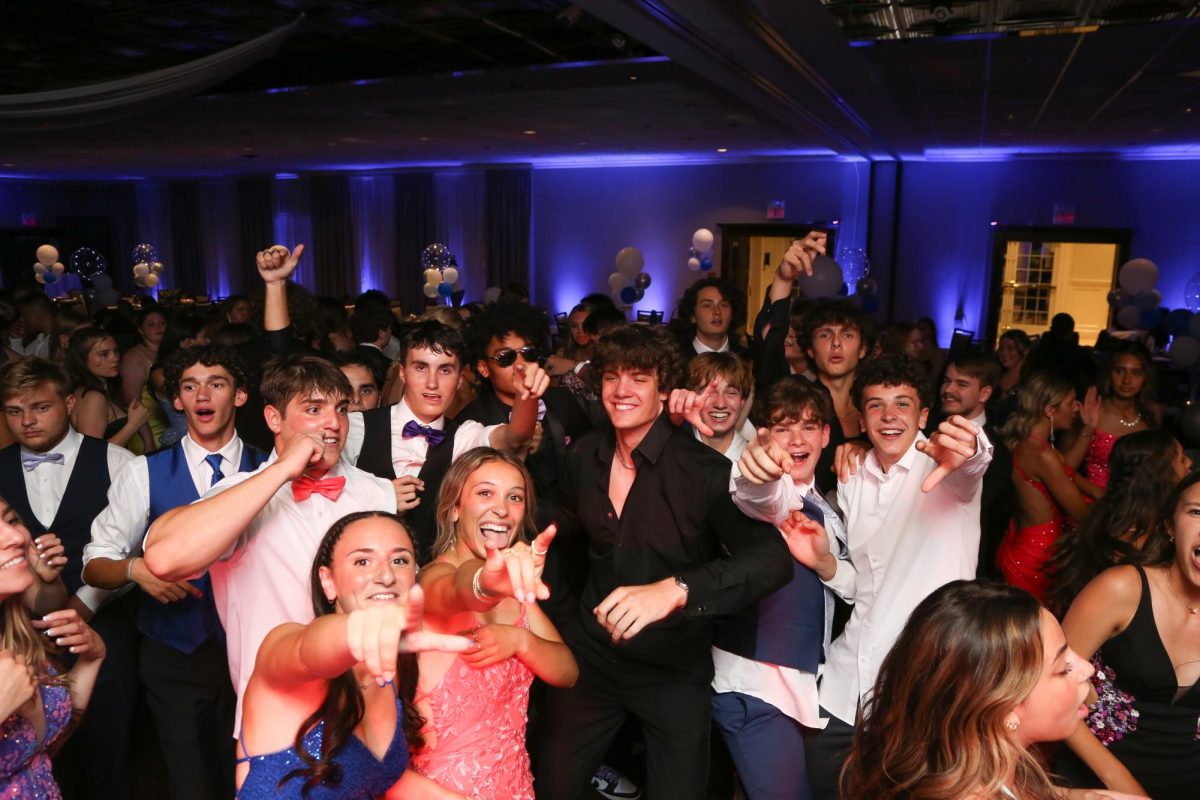 Underclassmen can look forward to prom as they get to celebrate the school year alongside NHS’ upperclassmen. This year, underclassmen can attend with the invitation of a junior or senior. Pictured here, prom goers pose for the cameras on the dance floor. All together, they spend the time having possibly one of the best nights ever with their friends and classmates full of energy and vibrance. Photo Credit: Images Studios Watertown. 
