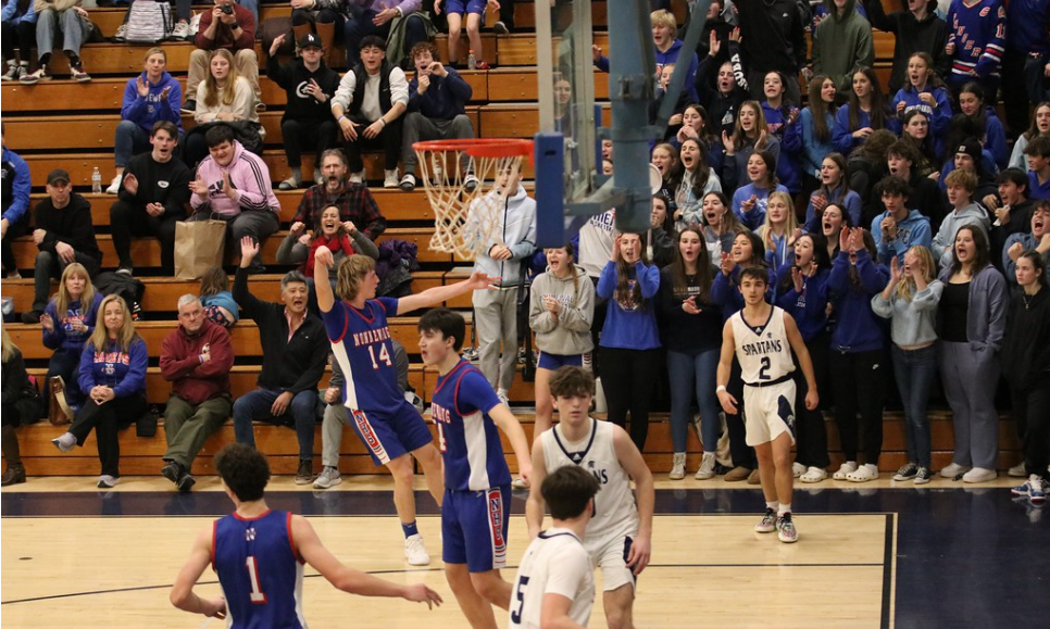 Celebrations at the high school level can sometimes get a team in the crowd riled up during a run in a game. Ben Roden gets the crowd hyped as he hits a crucial 3-pointer in a rivalry game at Shepaug in 2024. 
(Courtesy of Noreen Chung) 
