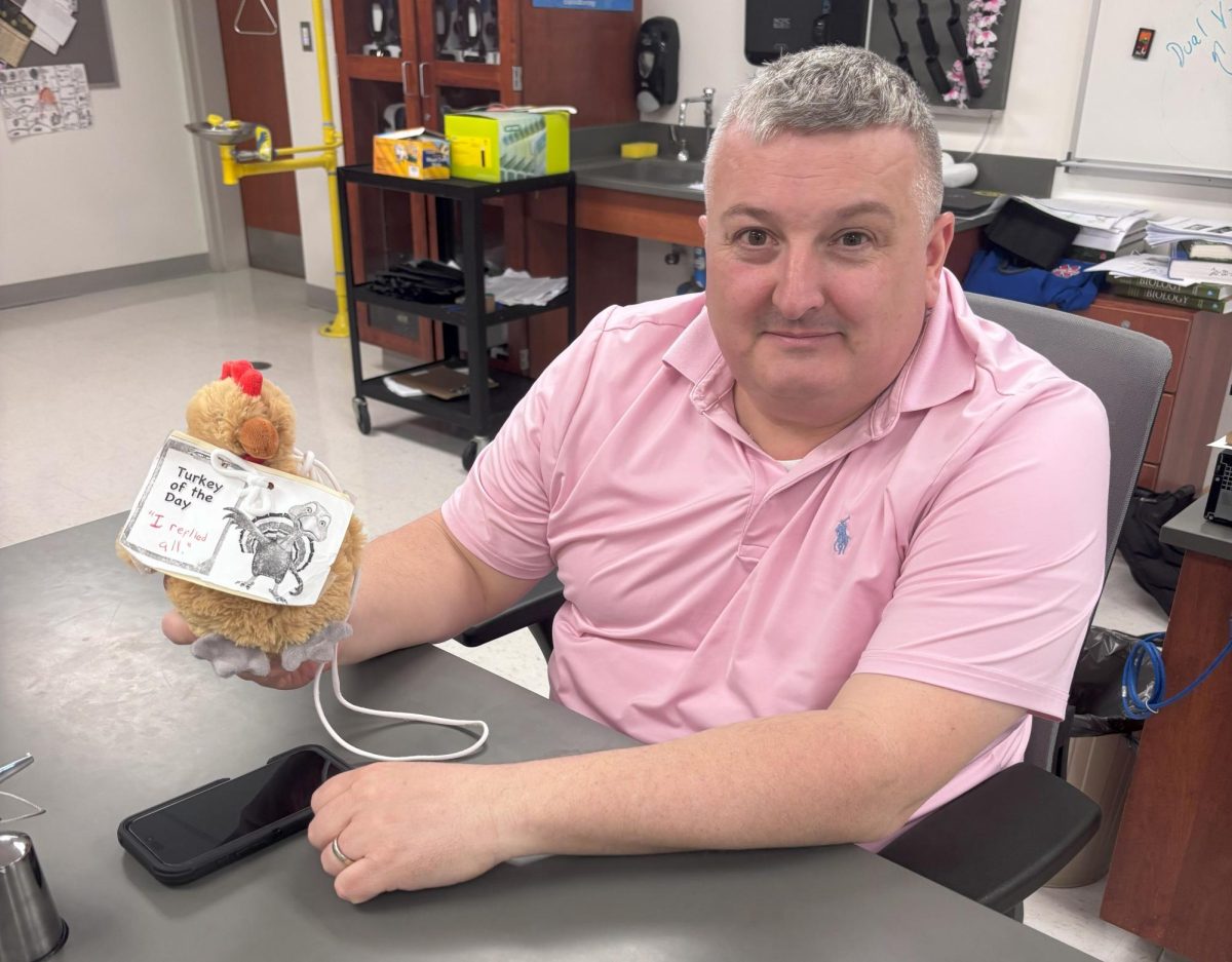 Toby Denman holds up his creation of the reply-all turkey, a dog toy representing email etiquette at Nonnewaug.