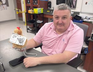 Toby Denman holds up his creation of the reply-all turkey, a dog toy representing email etiquette at Nonnewaug.